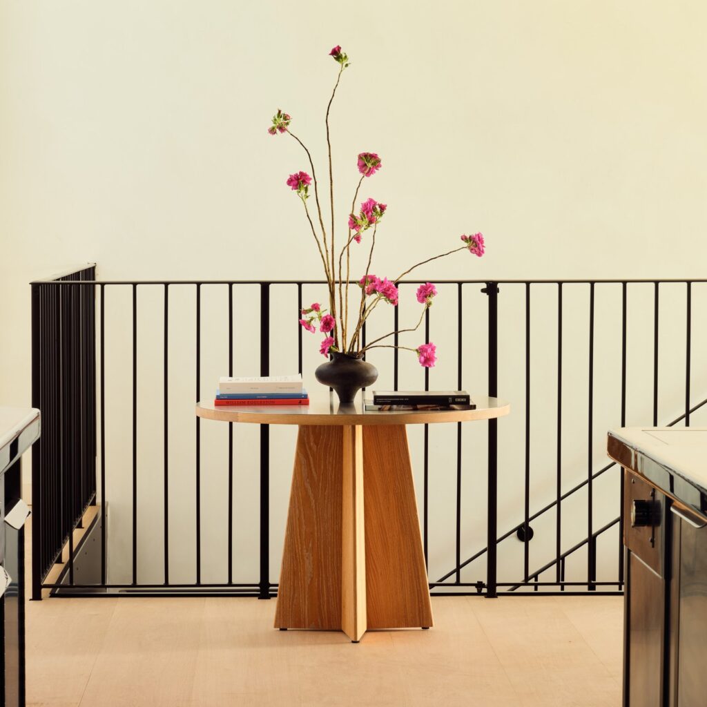 Round oak table with pink blossom at Lunette